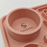 A close-up of a Somasso silicone pet feeder bowl in a dusty rose pink color, featuring measurement markings (150ml, 100ml, 60ml) and the Somasso logo printed inside the bowl.