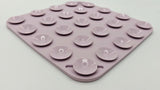A square silicone baking mat in a dusty lavender-purple color, featuring 24 suction cups arranged in a grid pattern on its top surface, photographed on a clean white background.